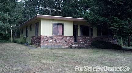Front of house
						:
						Many shade trees on this little over 1 acre property