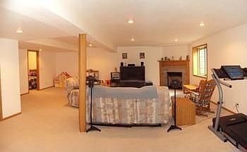 Huge family room in the lower level with a gas fireplace and an egress window.