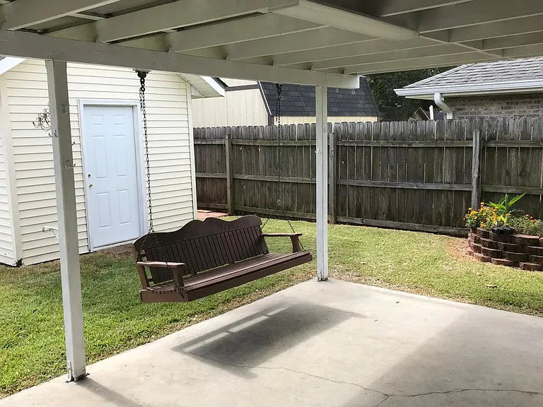 Backyard patio with cypress swing
