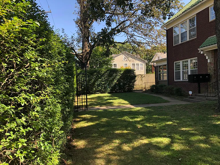 front yard with tall privet and gate for privacy