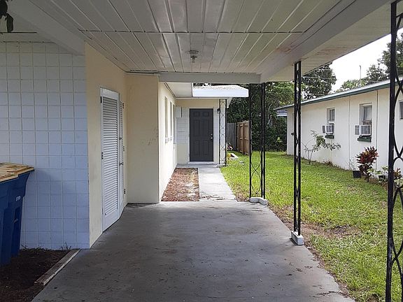 Entry with a long carport and washer/dryer closet outside
