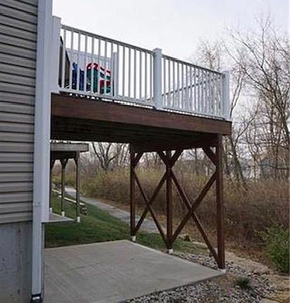 Above- patio deck.
Below- walk-out basement to cement patio.
Beyond- walking trail around the development and to the two pools in the complex.