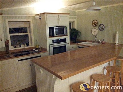 Kitchen with glasstop stove and wall oven