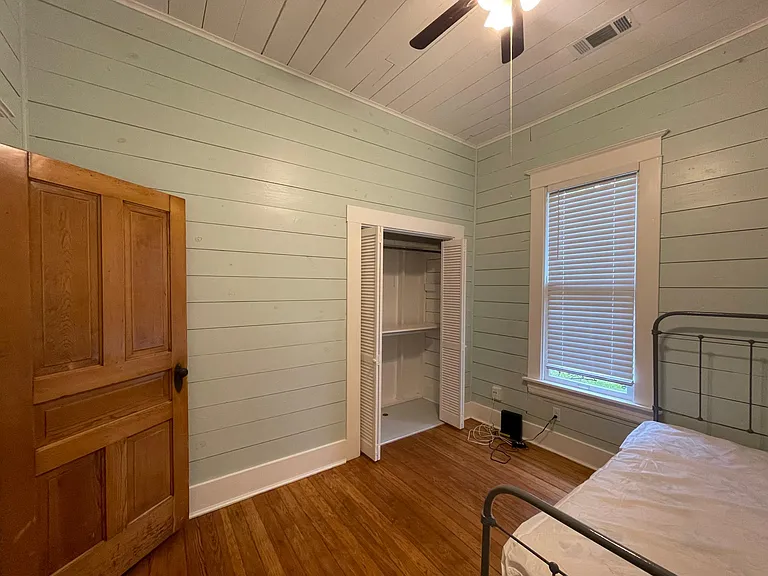 Back bedroom features a fan.