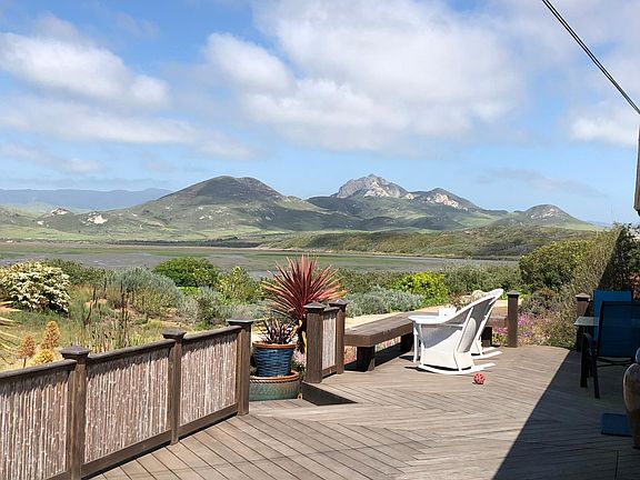 Deck and front door entrance from 3rd Street. The tide is out and the clouds are reflecting on the mountains in the distance. It is my favorite place to eat a meal and to read weather permitting.