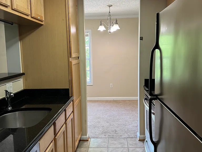 Galley-type, fully equipped Kitchen. Granite Countertops and Tall Cabinets.
