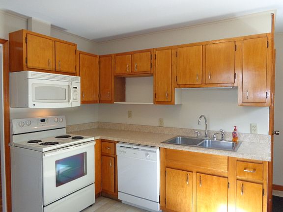 Fully equipped kitchen with new countertop, hardware and vinyl flooring.
