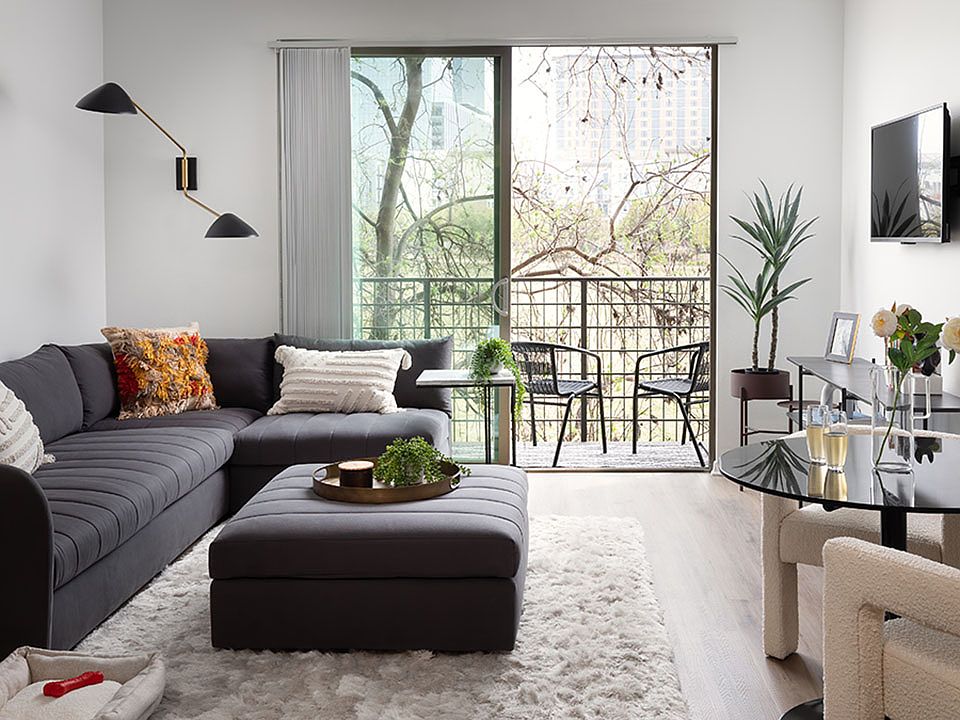 Apartment living room with wood-style flooring with balcony or patio.