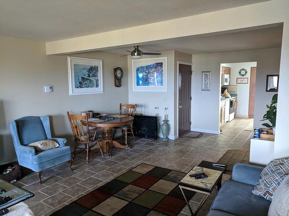 Living room facing front door entrance and entrance to kitchen.
