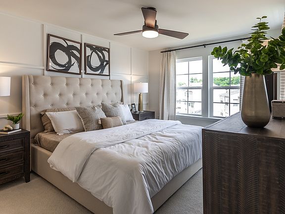 Carpeted owner s suite with double window in a DRB Homes York II model at the Archer s Rock communit