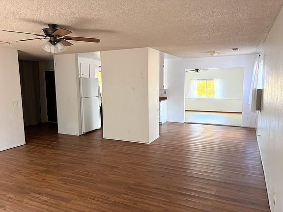 Connected living room, dining room, kitchen and family room with just enough separation for separate activities but a feeling of togetherness.