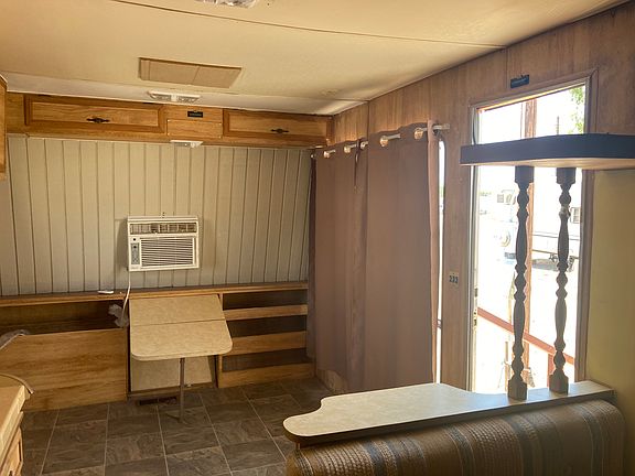 Living area has small table and ac in both bedroom and front of RV