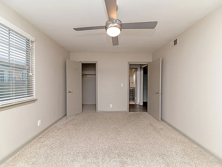 Cozy bedroom with carpet & ceiling fan
