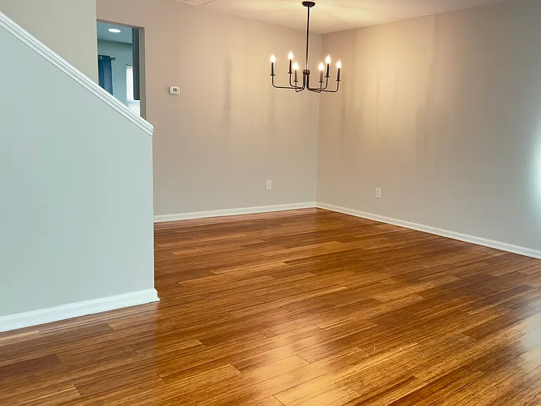 Living room and dining room with laminate flooring.