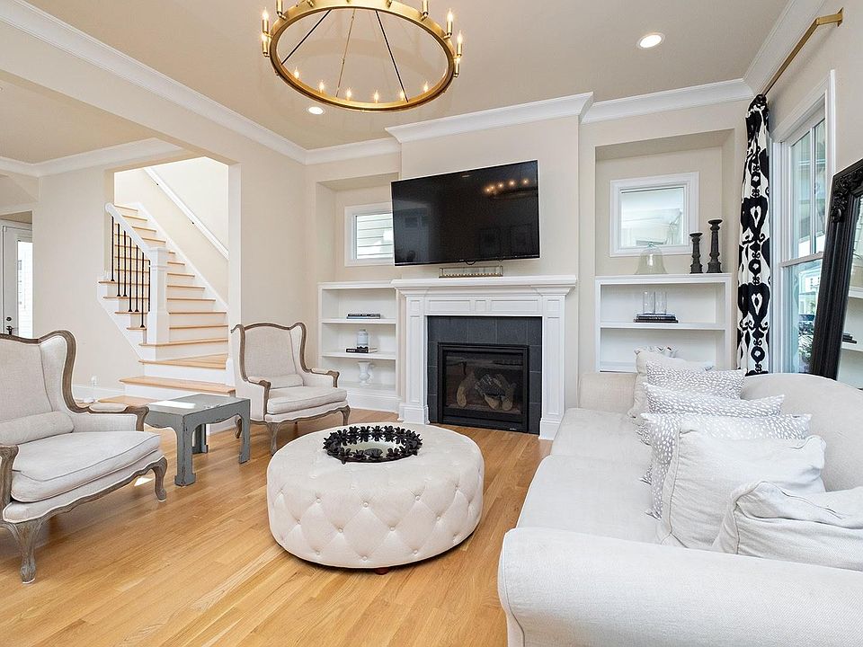 Stunning living room area with 10 foot high ceilings. Custom fireplace with built in display shelves