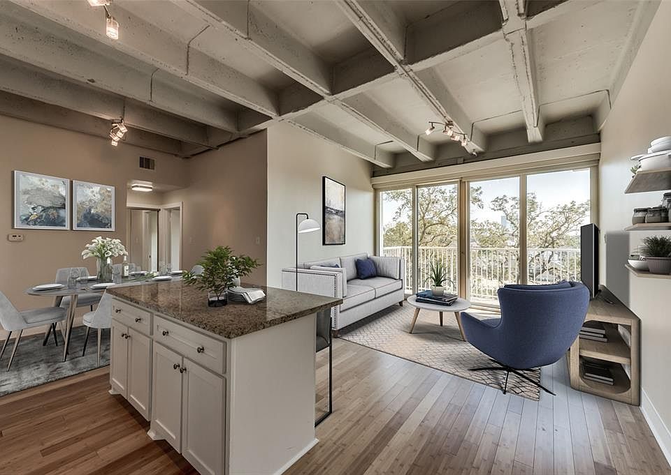 Walk into this open floor plan boasting gleaming bamboo floors with lofty exposed concrete ceilings as it looks virtually staged!