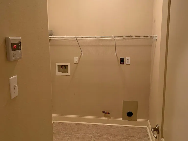 Laundry room with so much space to take care of your laundry needs! Gas tankless hot water access also pictured on wall so you will never run out of hot water again!