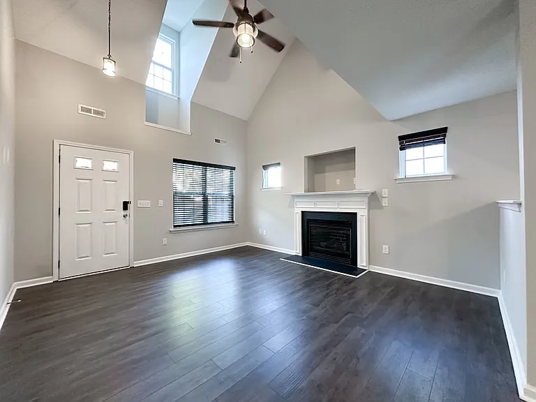 High ceiling living room and cozy fireplace.