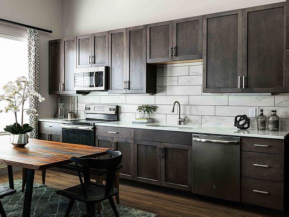 Modern kitchen with quartz countertops and slate appliances