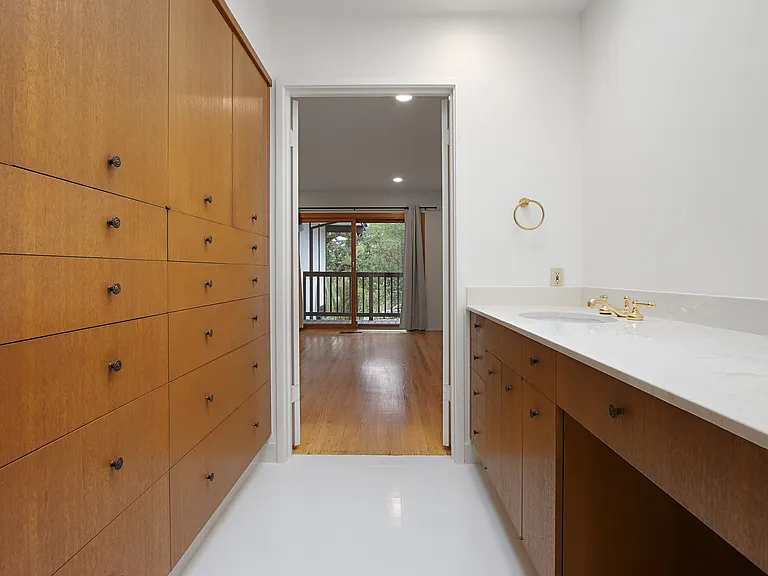Primary bathroom with floor to ceiling built in mahogany custom cabinetry