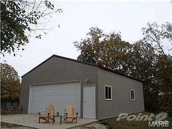 27'x32' detached garage with concrete floor and electric opener