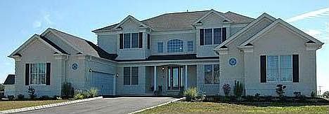 Exterior front with stucco finish, open front porch and 4 garages facing in.