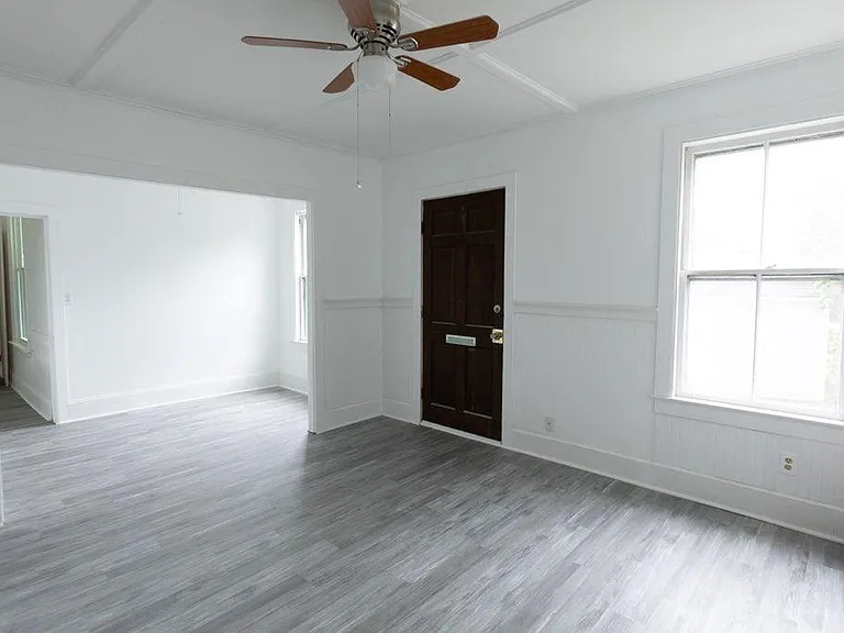 Entry door into Living Room with Dining room in background.