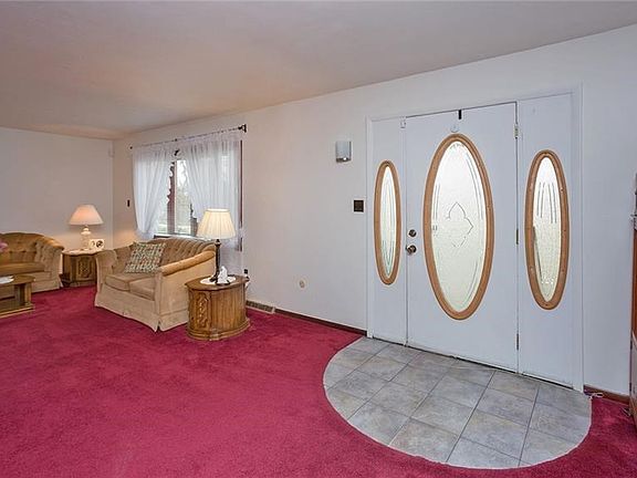 The formal living room offers a bay window with tons of natural light.