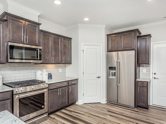 Open Kitchen with Breakfast Bar Island and walk-in Pantry
