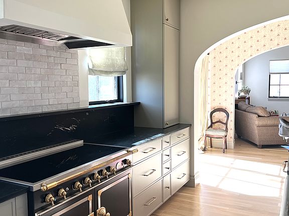 Kitchen archway to dining, to living. Oak flooring in lower level.