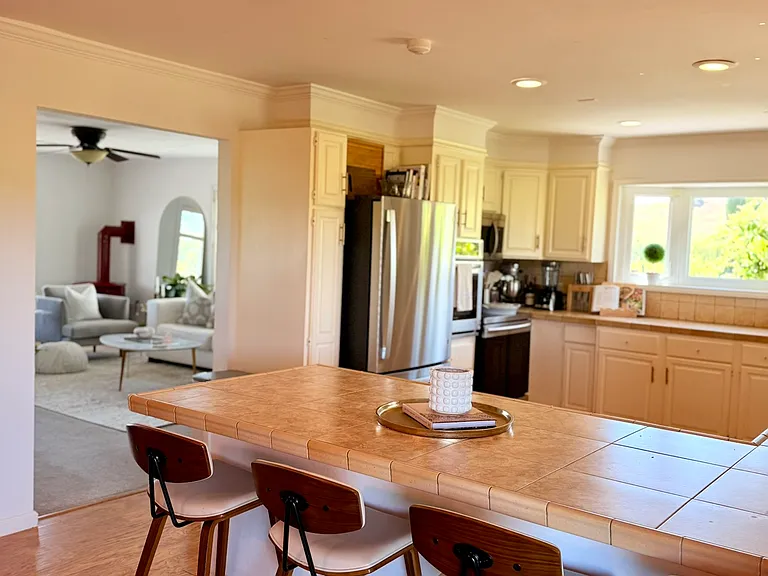Kitchen eating bar looking into livingroom.