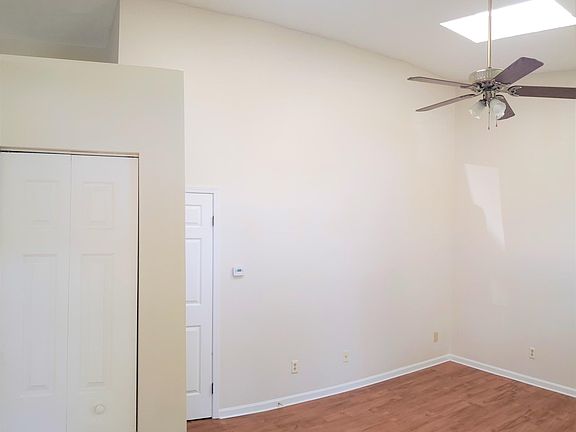 Family room with two skylight and beautiful ceiling fan with lights.
