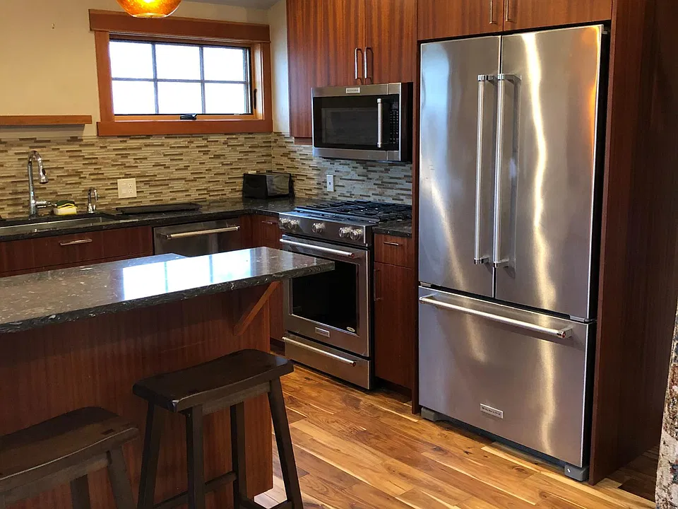 Kitchen with full oven, microwave oven, Fridge, dishwasher, garbage disposal. On demand hot water at sink. Under cabinet lighting.