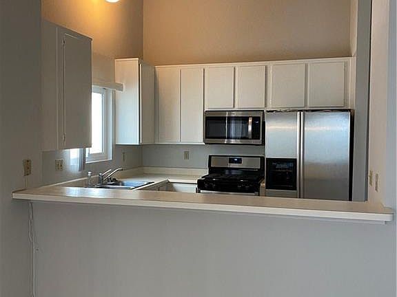 Freshly painted cabinets and stainless appliances.