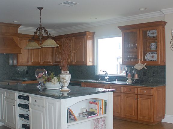 Custom kitchen with stainless steel appliances and granite countertop