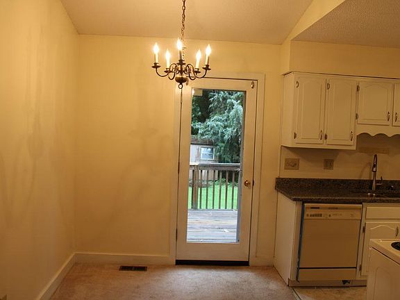Dining Area with door to backyard, kitchen with new granite countertops