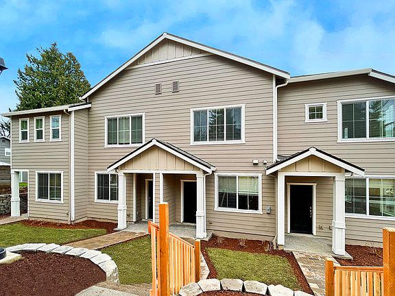 The Apple unit, pictured here on the right, features a covered entry and abundant windows.