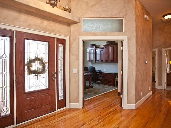 Stunning entrance with tall ceilings, gleaming hardwood floors and open concept floor plan beckon family and visitors alike...