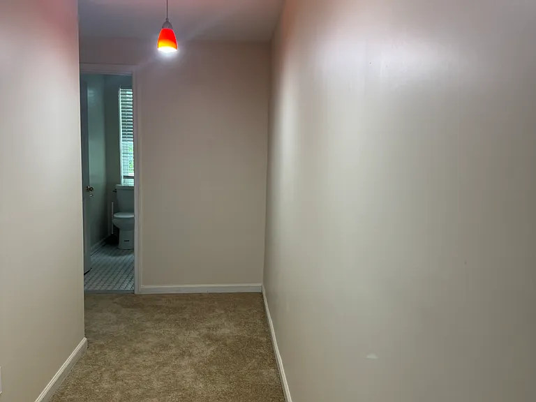 long expansive hallway connects the rooms. At the end of the hallway is the full bathroom.