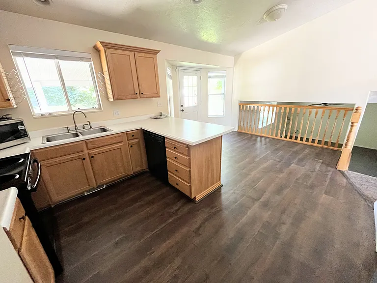 Brand new Pergo laminate wood-style flooring in warm, natural wood with exceptional durability and easy maintenance.
