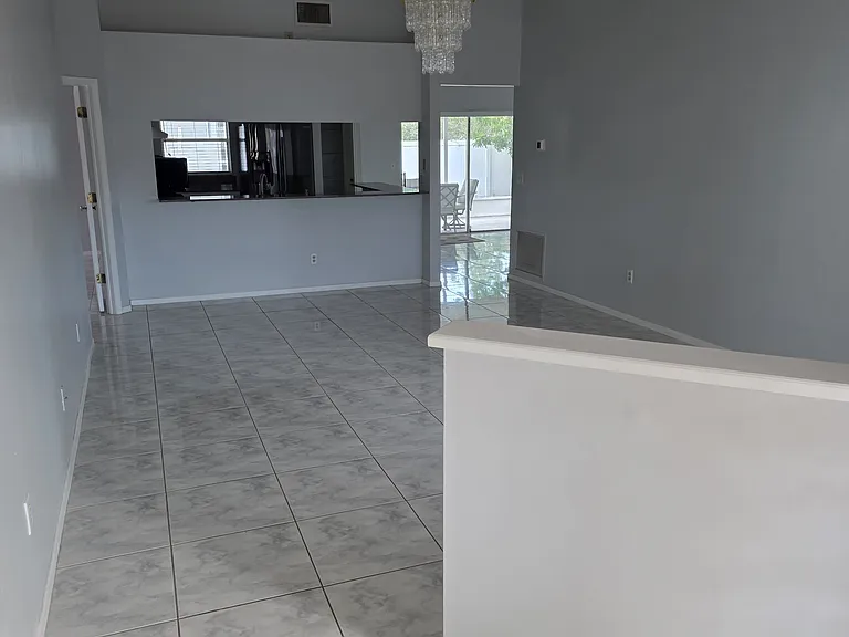 living room picture showing entrance to kitchen and dining area