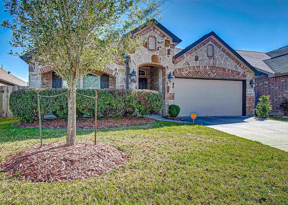 Beautiful traditional home with stone accents, nice landscaping and double wide driveway with two car garage.
