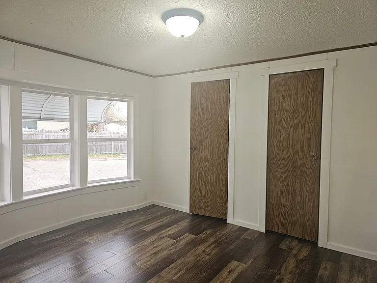 1st bedroom with brand new vinyl windows, wood vinyl plank flooring, new trim, new light fixture, and freshly painted.