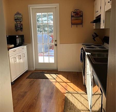 The bright kitchen offers convenient access to the deck for easy grilling. 12'x9'