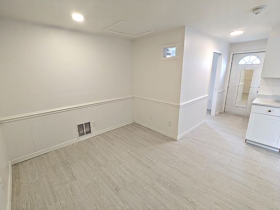 Facing kitchen, front door, bedroom door, living room