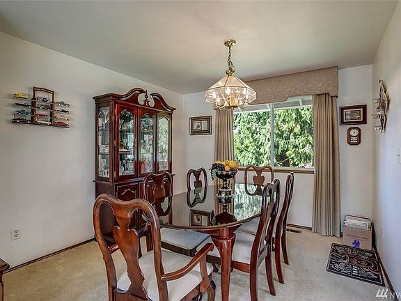 The formal living room has plenty of room for large gatherings and is open to the living room 