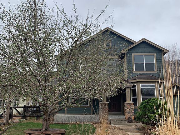 Beautiful apple tree in front yard with sweet bench to sit on.