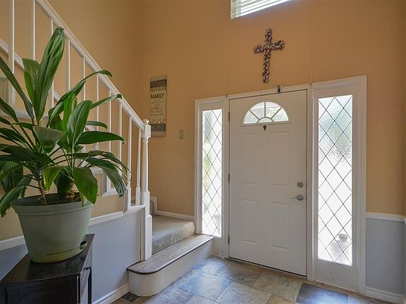 Upon entering you find a lovely corridor showcasing custom paint, beautiful floors, high ceilings, and ample lighting!