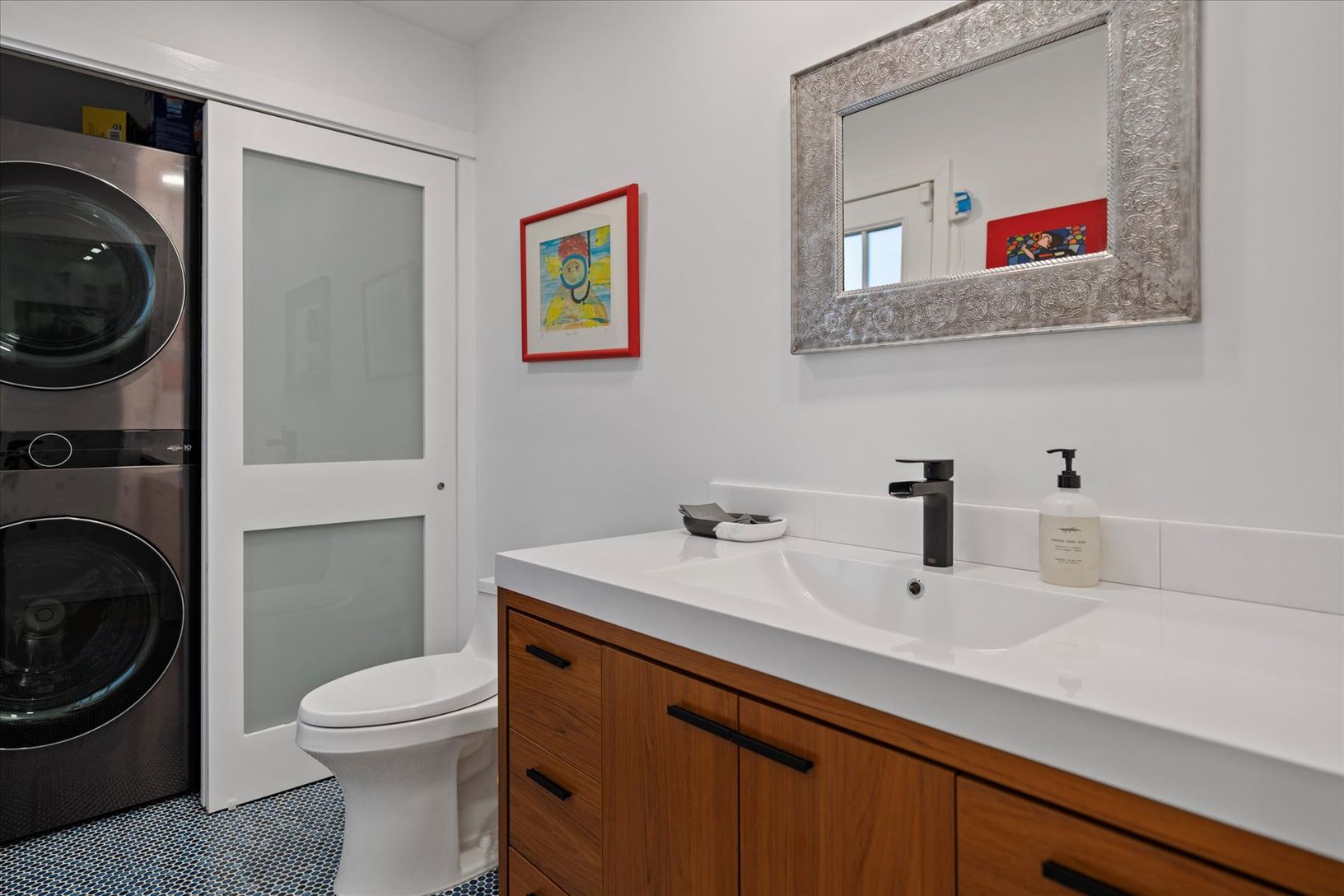  Main powder room with stackable full sized washer/dryer. Conveniently opens to the the rear deck.