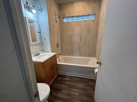 New tub, tile tub surround, new floor, new lighting and fan.